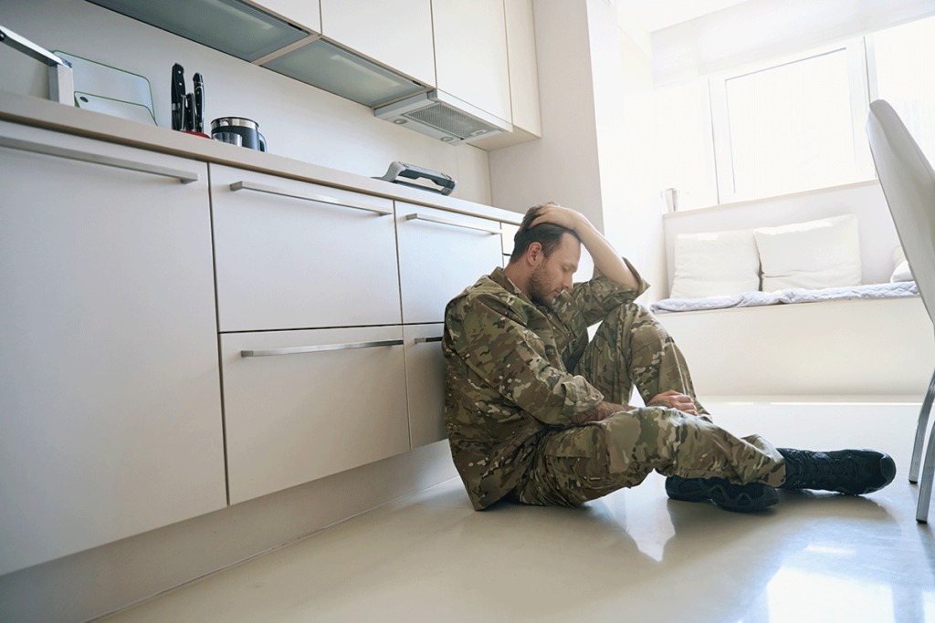 veteran on kitchen floor struggling while wondering about the link between veterans and addiction