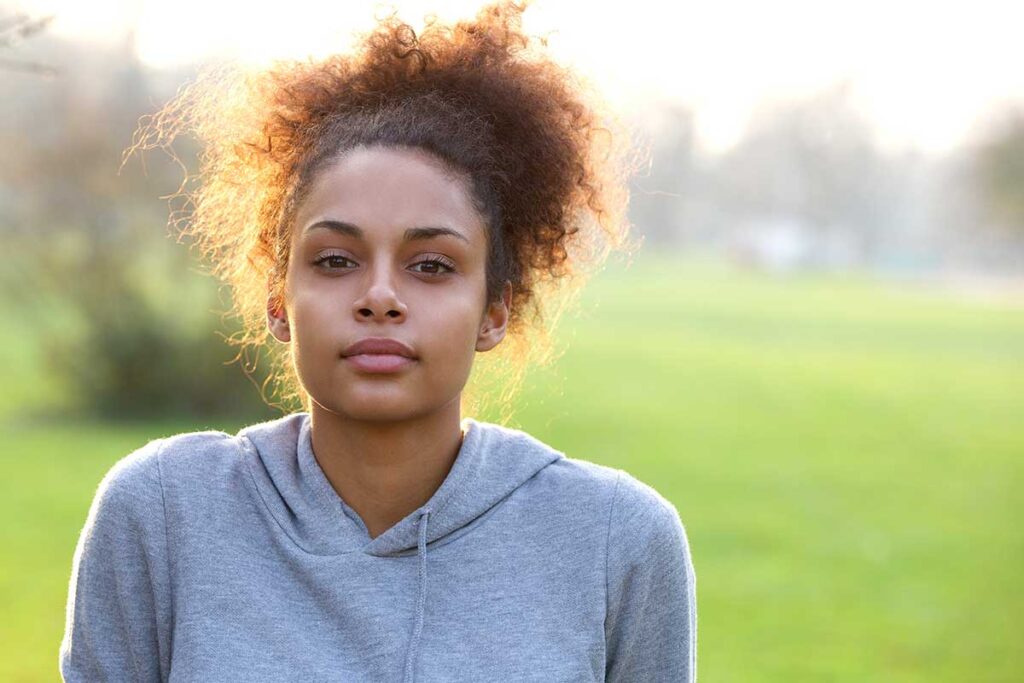 person outdoors staring straight ahead while wondering about the difference between dysthymia vs major depression